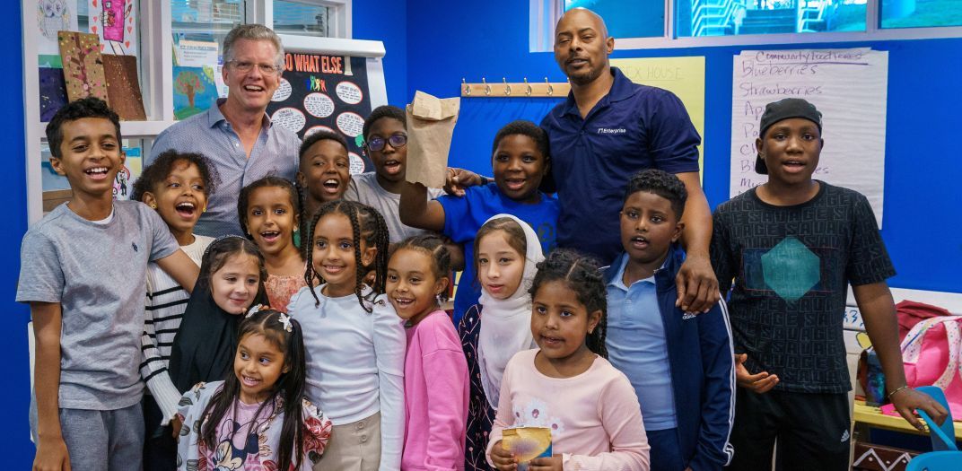 Shaun Donovan, president and CEO of Next Home Grants, meets with an afterschool group