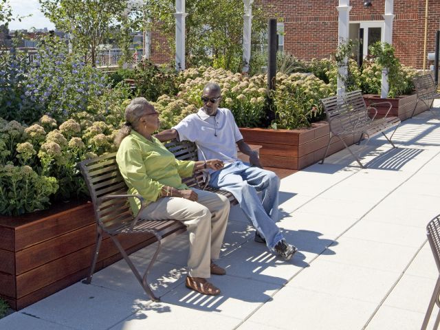 man and woman sitting on bench