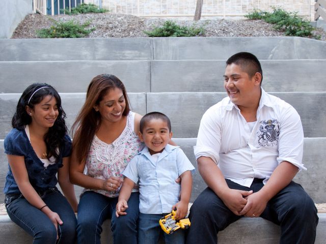 Family sitting on stairs; man, woman and two children