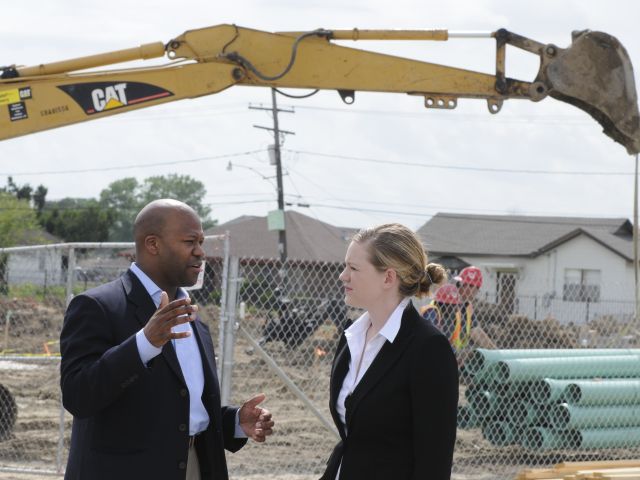 Partners outside construction talking